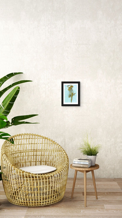 Limited Edition Fine Art Giclée Print of a watercolour female figure embodying the season of Winter, A4 sized, displayed on a wall. The colours are an earthy gold and brown with graphite on a beautiful blue background. 